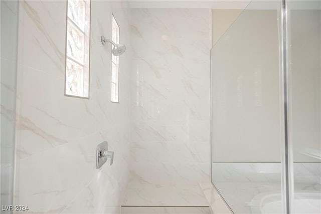 bathroom with tiled shower