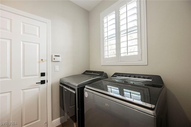 clothes washing area featuring washing machine and clothes dryer