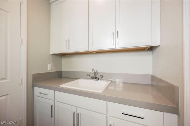 kitchen featuring sink and white cabinets