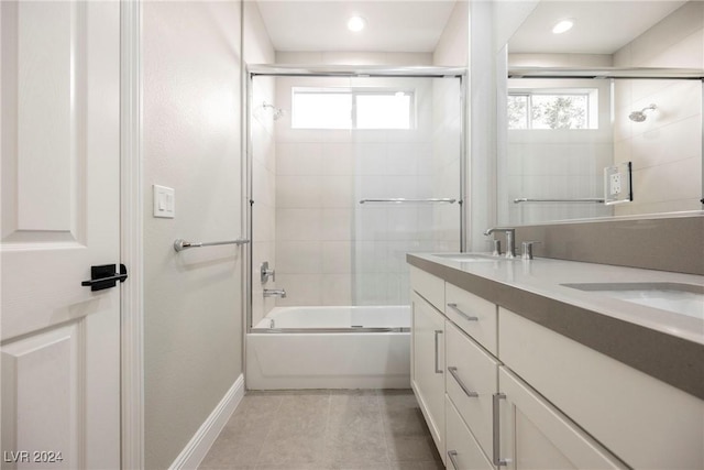 bathroom featuring tile patterned floors, vanity, and bath / shower combo with glass door