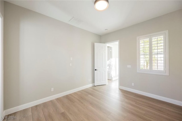 spare room with light hardwood / wood-style floors