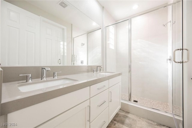 bathroom featuring vanity and an enclosed shower