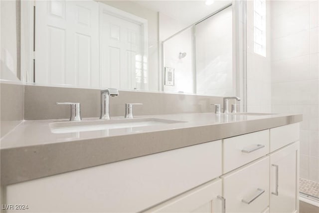 bathroom with an enclosed shower and sink