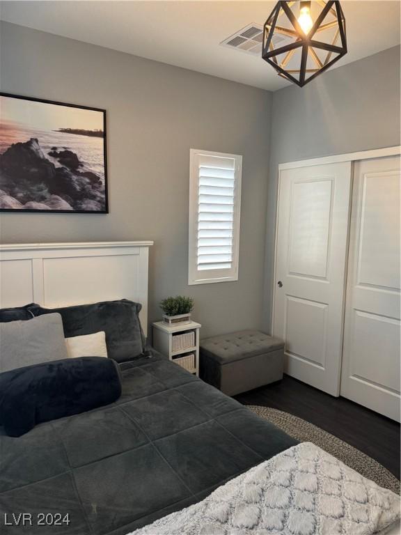 bedroom with a closet and dark hardwood / wood-style floors