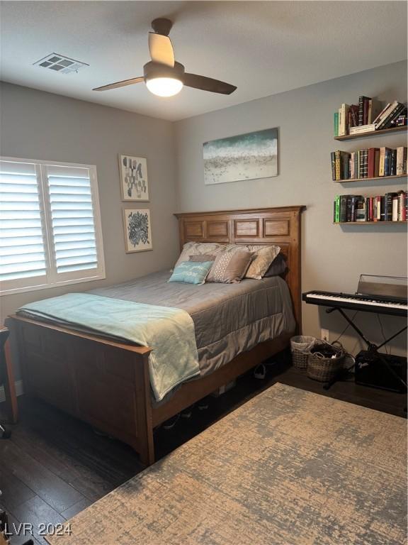 bedroom featuring ceiling fan and dark wood-type flooring