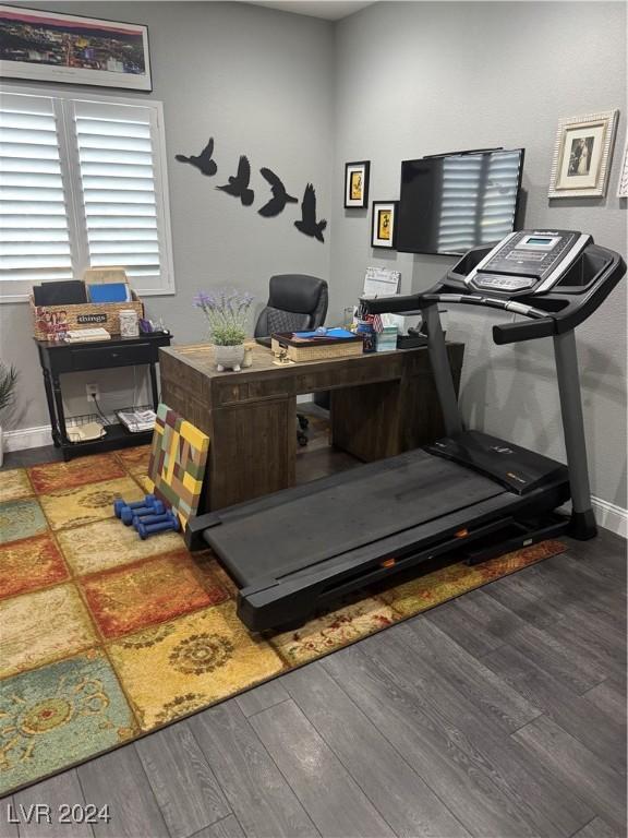 workout area featuring dark hardwood / wood-style floors