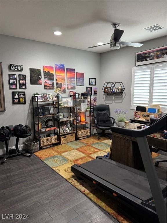 exercise room with ceiling fan and hardwood / wood-style flooring