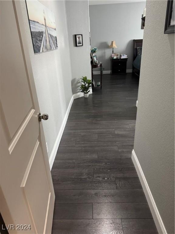 hall with dark hardwood / wood-style flooring