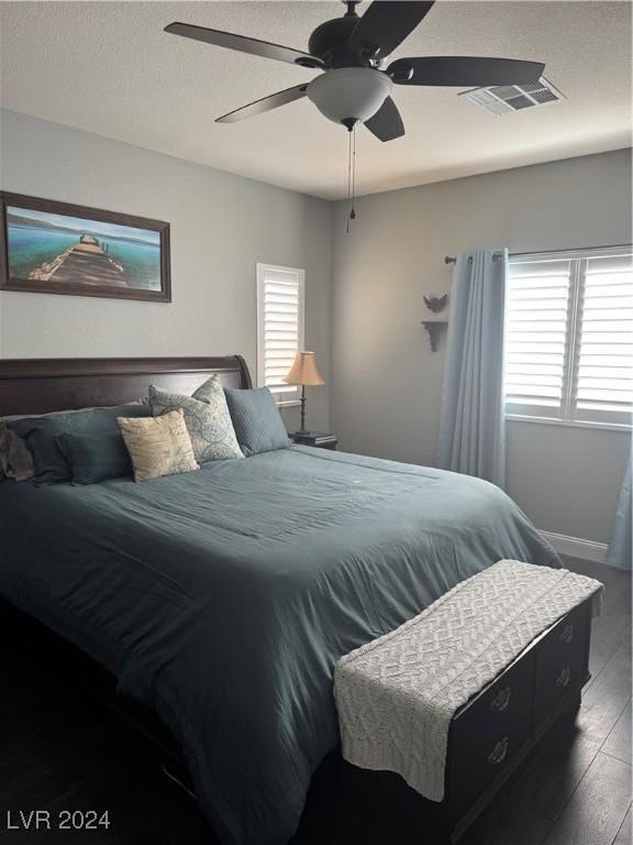 bedroom featuring ceiling fan and dark hardwood / wood-style flooring