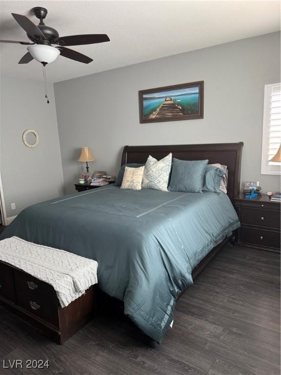 bedroom featuring ceiling fan and dark hardwood / wood-style flooring