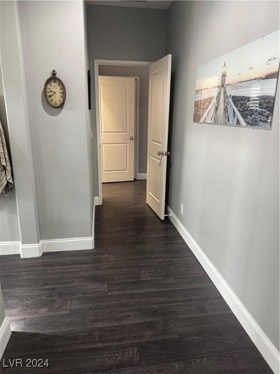 hallway with dark hardwood / wood-style floors