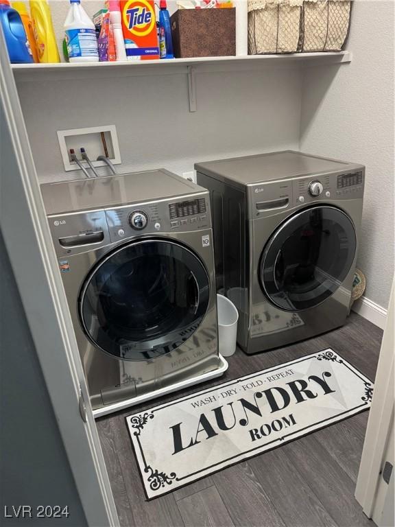 clothes washing area featuring washer and dryer and dark hardwood / wood-style floors