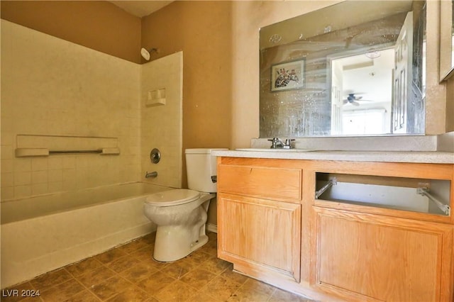 full bathroom featuring vanity, ceiling fan, tiled shower / bath, and toilet