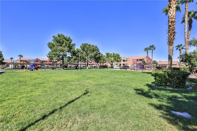 view of property's community with a lawn and a playground