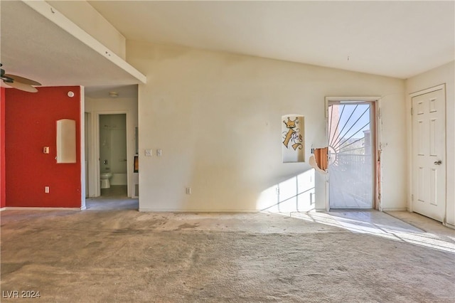 carpeted entrance foyer featuring vaulted ceiling and ceiling fan