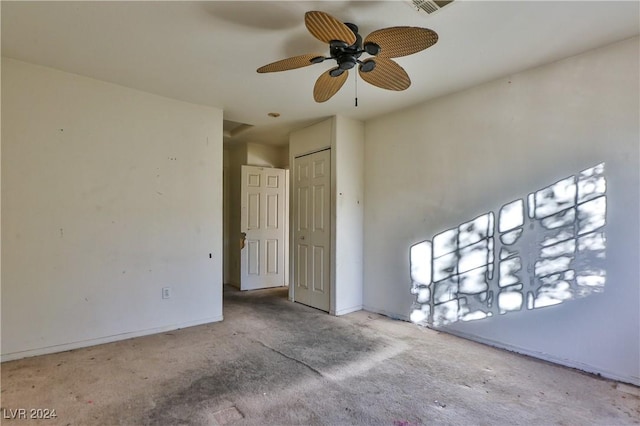 carpeted spare room with ceiling fan