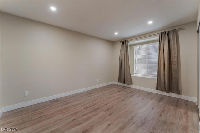 spare room with light wood-type flooring