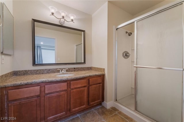 bathroom with tile patterned floors, vanity, and an enclosed shower