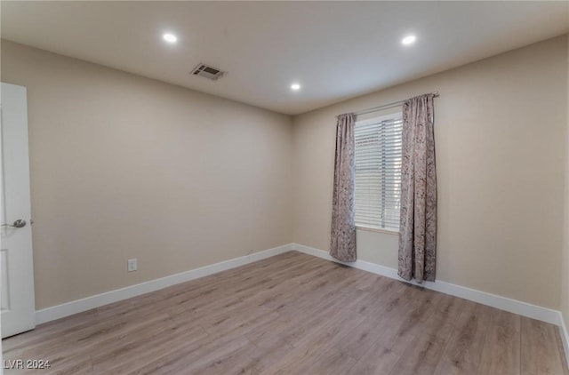 empty room with light hardwood / wood-style floors