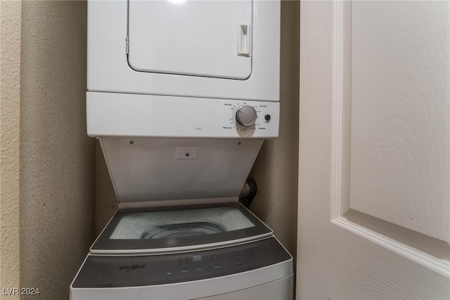 washroom featuring stacked washer / dryer