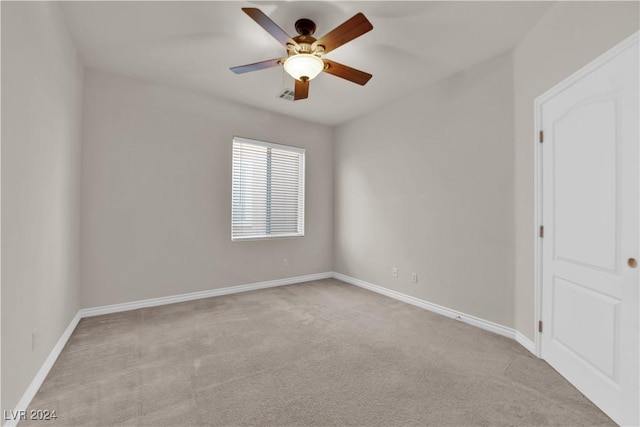 empty room with light colored carpet and ceiling fan