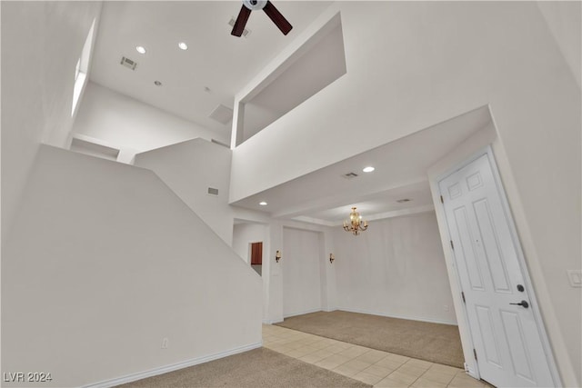 interior space featuring ceiling fan with notable chandelier