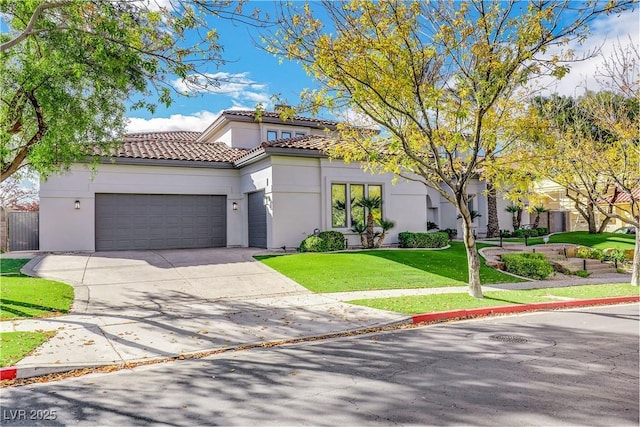 mediterranean / spanish home with a garage and a front lawn