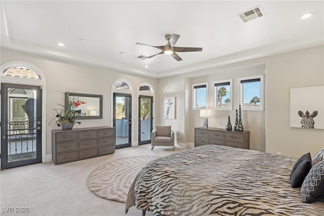 carpeted bedroom with recessed lighting, visible vents, a raised ceiling, and access to exterior