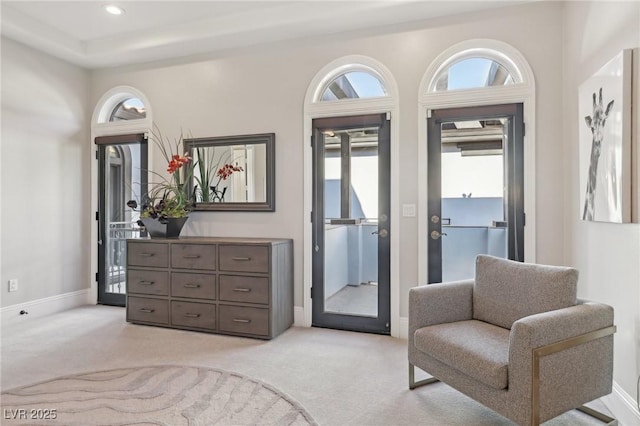 living area with light carpet, recessed lighting, and baseboards