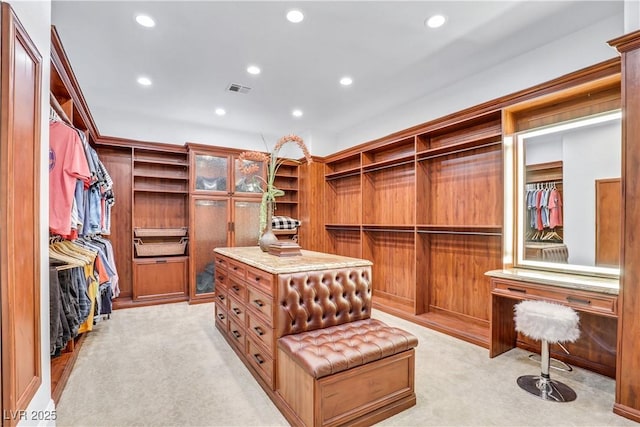 spacious closet with light colored carpet and visible vents