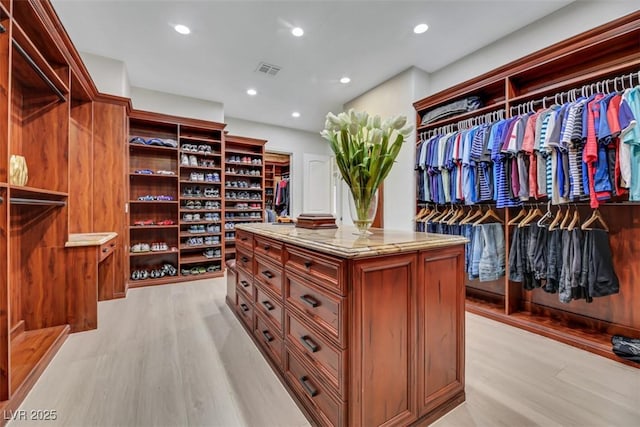 spacious closet featuring visible vents and light wood finished floors