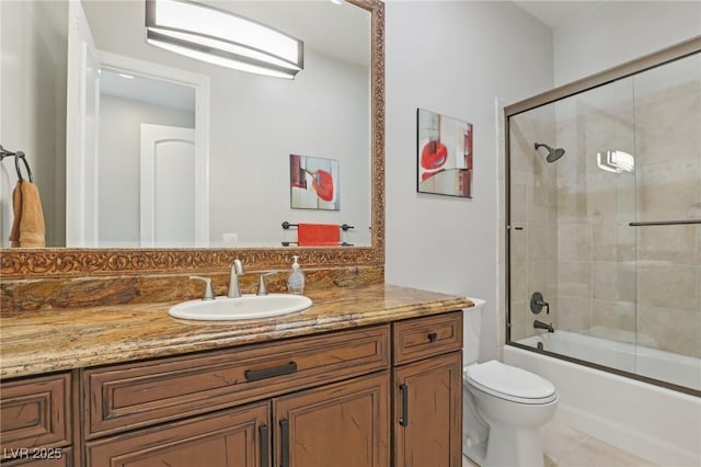 full bathroom with vanity, toilet, and shower / bath combination with glass door