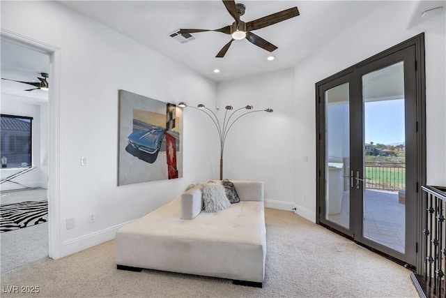 living area featuring visible vents, baseboards, carpet, and french doors