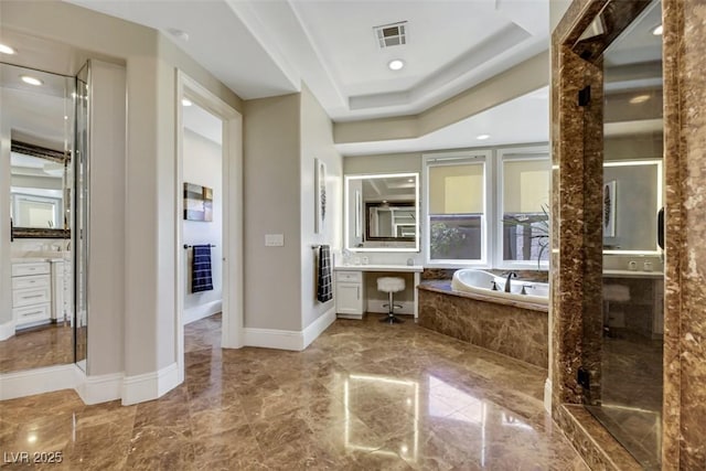 bathroom featuring vanity, a garden tub, visible vents, a raised ceiling, and marble finish floor