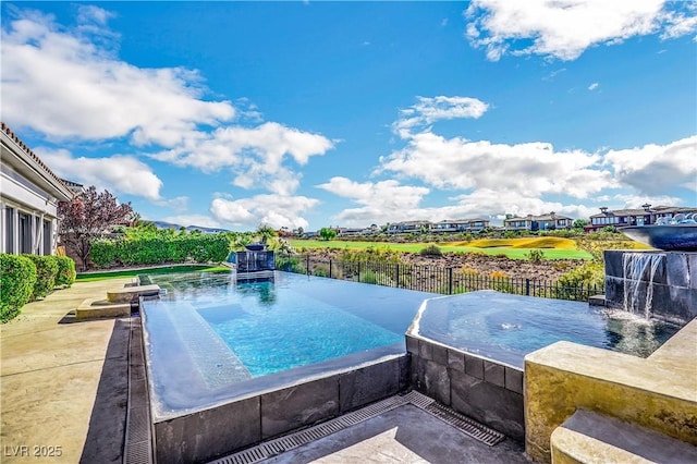 view of pool with pool water feature and a patio