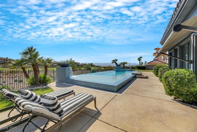 view of swimming pool with a fenced in pool, a patio, and fence