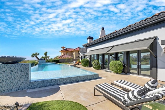 view of pool featuring an infinity pool and a patio area