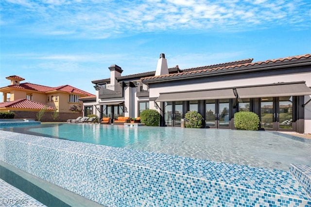 view of swimming pool with an infinity pool