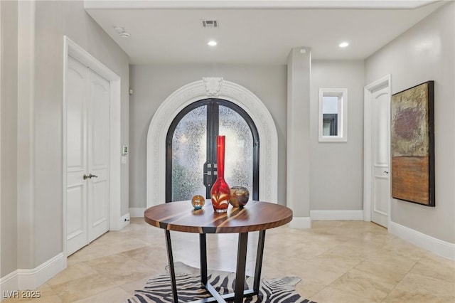 entryway featuring recessed lighting, visible vents, and baseboards