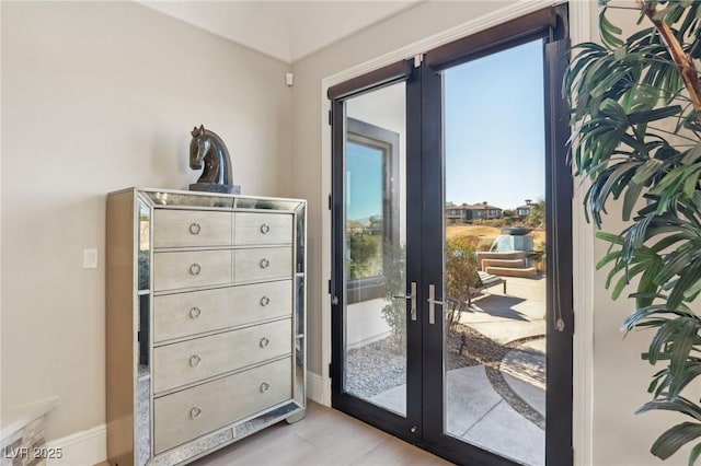 entryway featuring french doors and baseboards