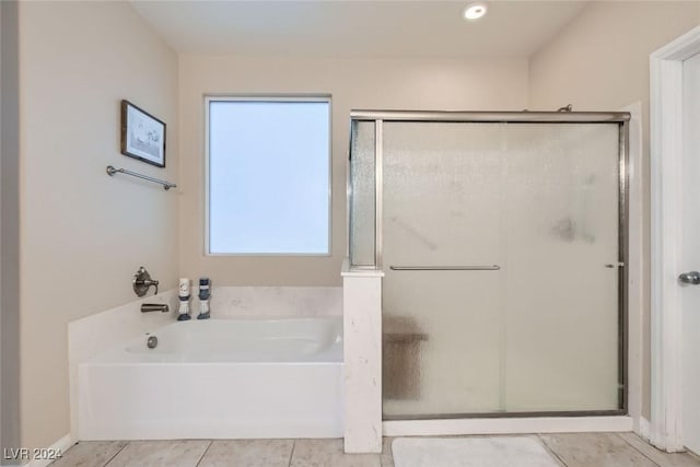 bathroom featuring tile patterned floors and shower with separate bathtub