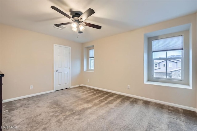 unfurnished room featuring ceiling fan, carpet floors, and a healthy amount of sunlight