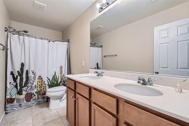 bathroom featuring tile patterned floors, vanity, and toilet