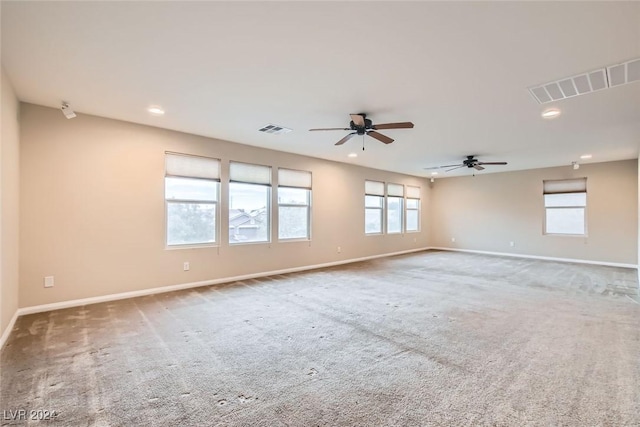 spare room with ceiling fan and carpet floors