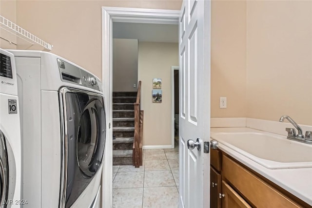 laundry area featuring light tile patterned floors, sink, and washer / clothes dryer