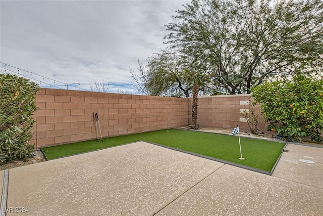 3605 Sapphire Sea Ct, North Las Vegas, NV 89031 - fenced backyard featuring a putting area and a patio area