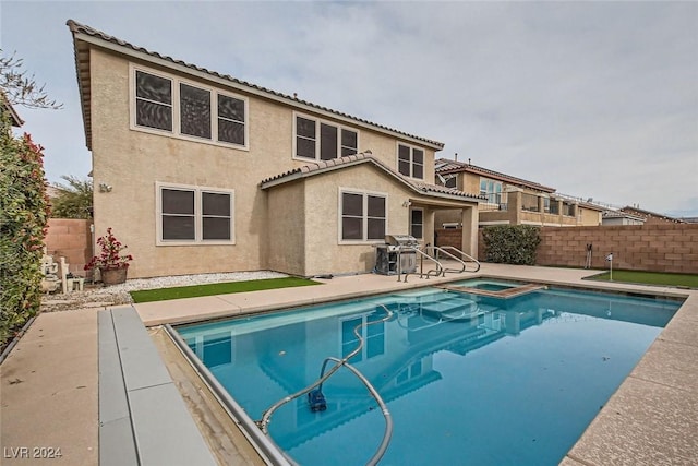 3605 Sapphire Sea Ct, North Las Vegas, NV 89031 - view of swimming pool with area for grilling, a fenced backyard, a patio area, and a pool with connected hot tub