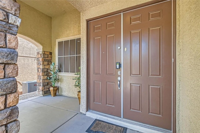 3605 Sapphire Sea Ct, North Las Vegas, NV 89031 - doorway to property with stucco siding, stone siding, and central AC unit