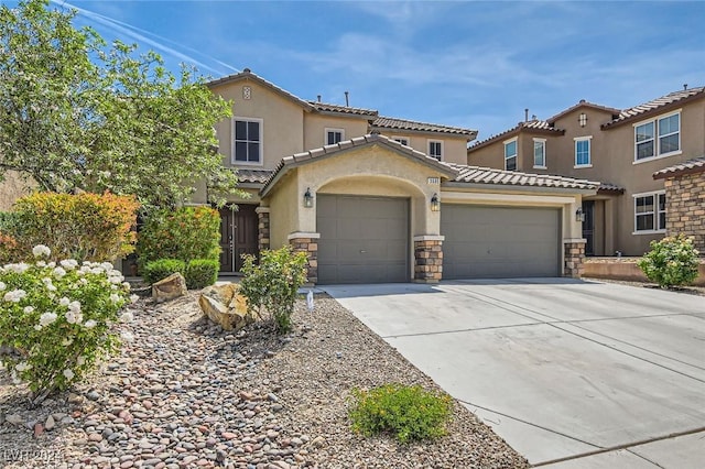 3605 Sapphire Sea Ct, North Las Vegas, NV 89031 - mediterranean / spanish house with a garage, a tiled roof, driveway, stone siding, and stucco siding