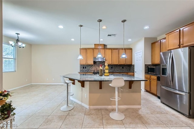 3605 Sapphire Sea Ct, North Las Vegas, NV 89031 - kitchen featuring appliances with stainless steel finishes, decorative backsplash, dark stone countertops, a kitchen breakfast bar, and recessed lighting